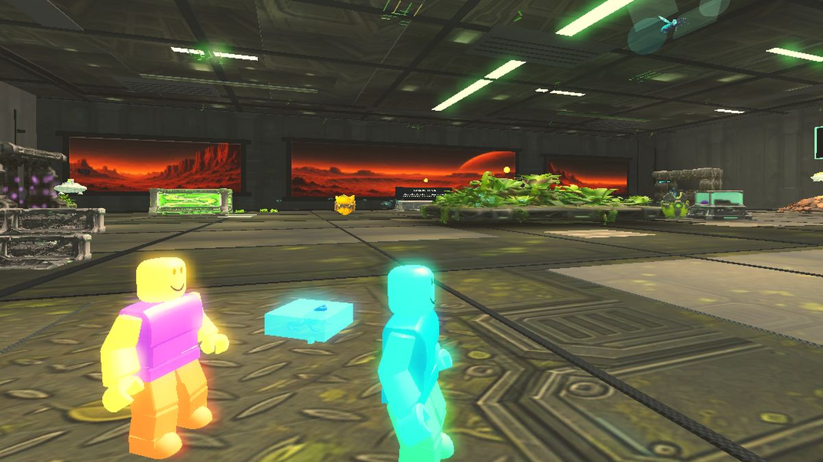 Two glowing players around a collectible cube in the Frogonauts space arcade
